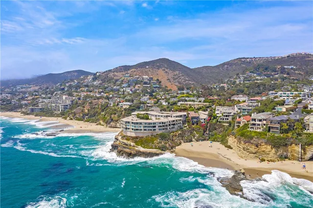 a view of a hallway with wooden floor and a living room