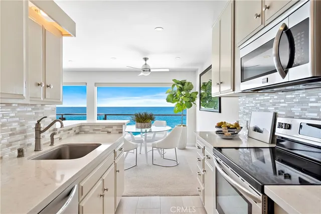 a kitchen with a sink cabinets and appliances
