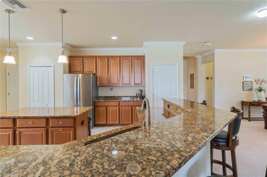 20370 Grazie Place Venice, FL 34293 - Photo 16 of 86 a kitchen with stainless steel appliances granite countertop a stove a sink and a refrigerator