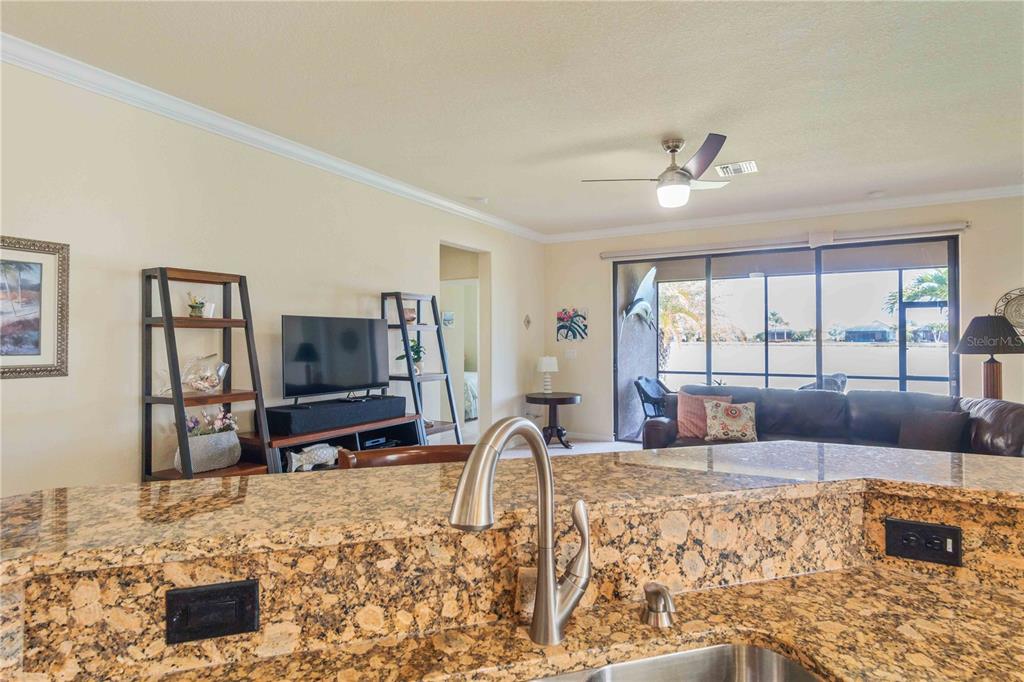 20370 Grazie Place Venice, FL 34293 - Photo 23 of 86 a living room with furniture flat screen tv and a stove