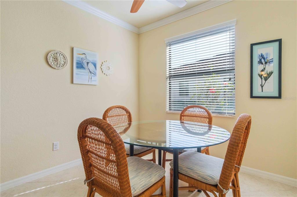 20370 Grazie Place Venice, FL 34293 - Photo 25 of 86 a view of a dining room with furniture and wooden floor