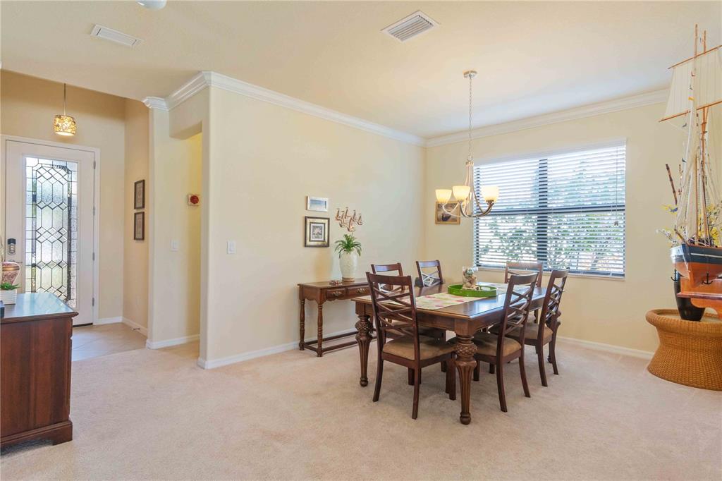 20370 Grazie Place Venice, FL 34293 - Photo 28 of 86 a view of a dining room with furniture and window