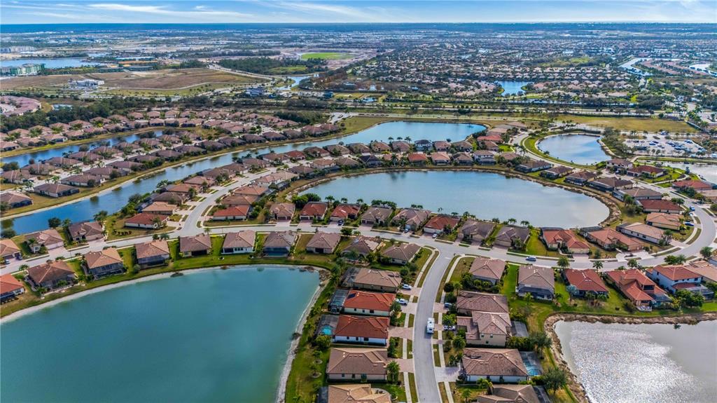 20370 Grazie Place Venice, FL 34293 - Photo 3 of 86 an aerial view of a city with a lake view