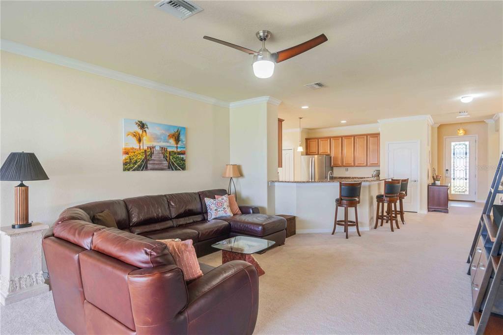 20370 Grazie Place Venice, FL 34293 - Photo 34 of 86 a living room with furniture and a flat screen tv