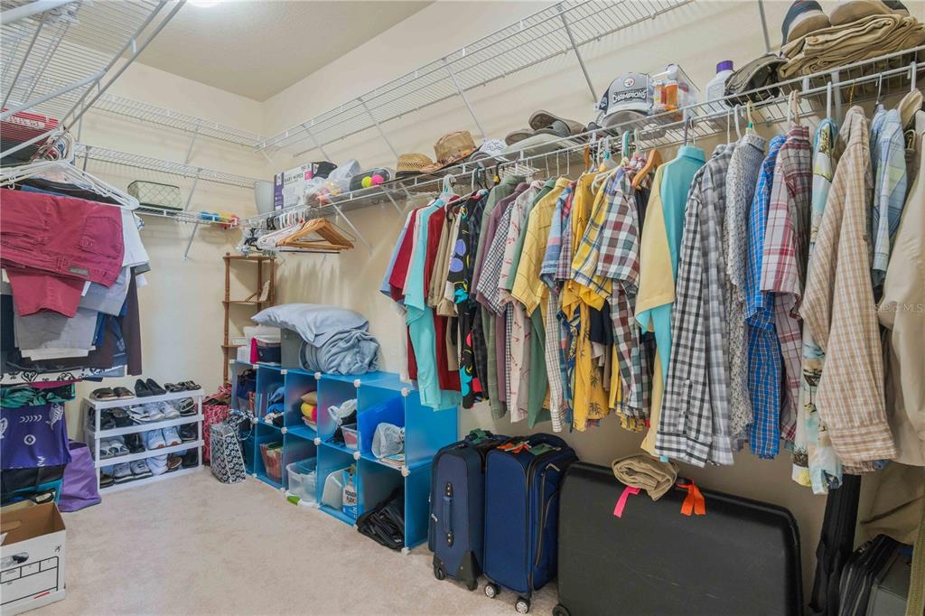 20370 Grazie Place Venice, FL 34293 - Photo 44 of 86 a view of walk in closet with clothes and shoes