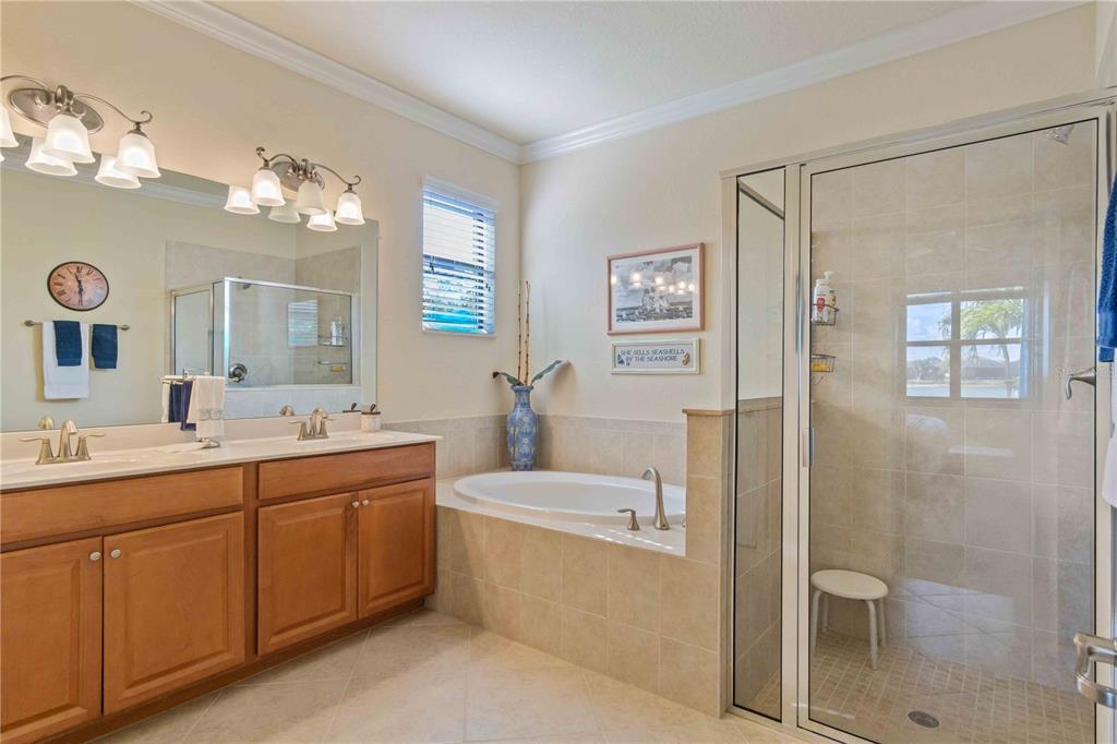 20370 Grazie Place Venice, FL 34293 - Photo 45 of 86 a bathroom with a double vanity sink mirror and shower