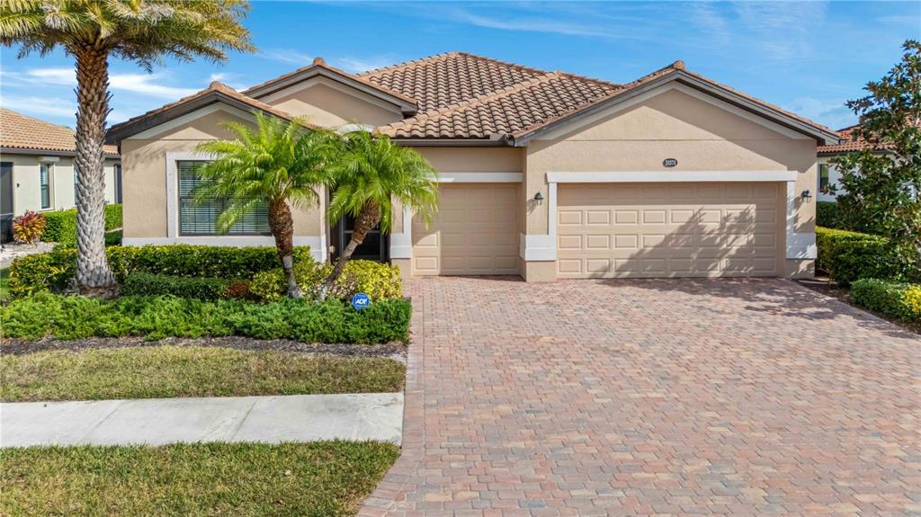 20370 Grazie Place Venice, FL 34293 - Photo 6 of 86 a front view of a house with a garden and plants