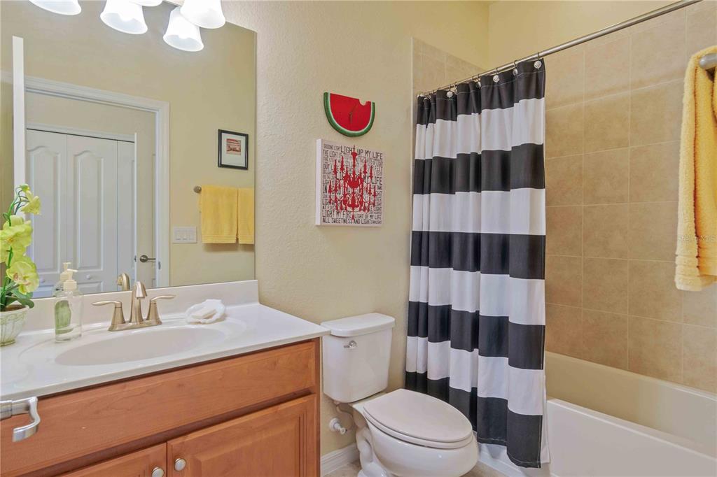 20370 Grazie Place Venice, FL 34293 - Photo 62 of 86 a bathroom with a sink a toilet a shower and a mirror