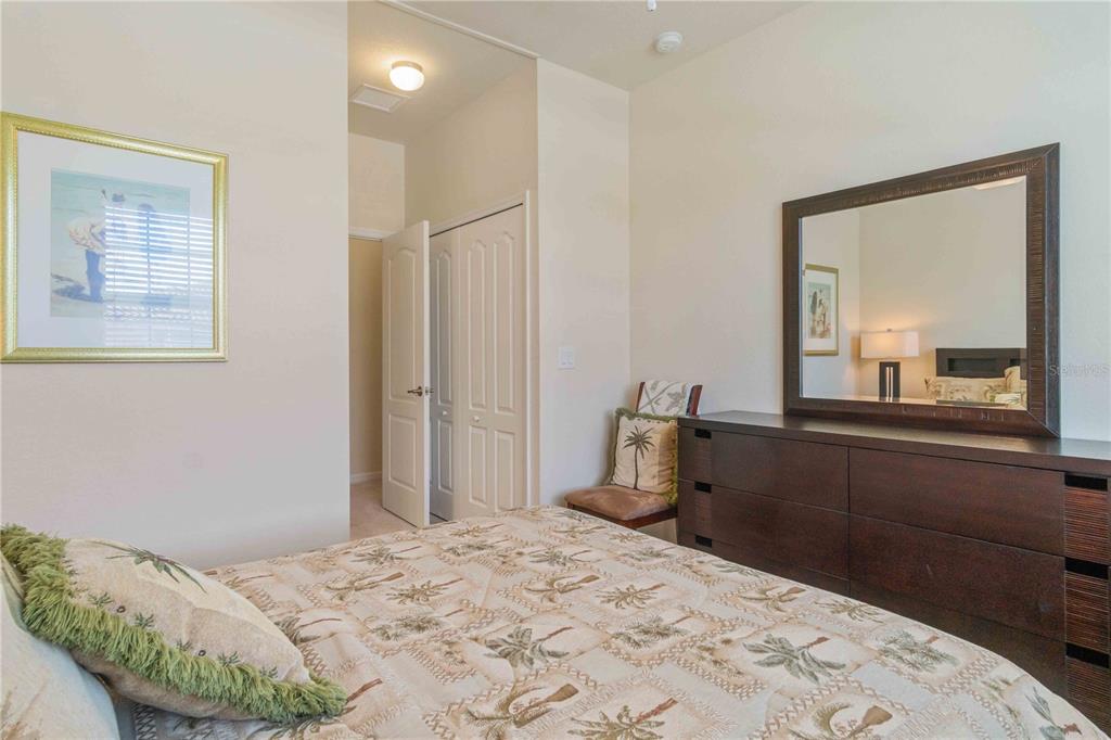 20370 Grazie Place Venice, FL 34293 - Photo 66 of 86 a bedroom with a bed and a dresser