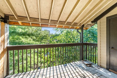 a view of a balcony with wooden floor