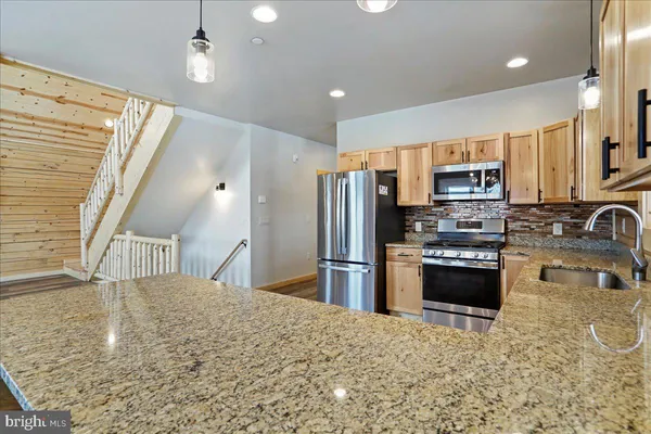 a kitchen with lots of counter top space and dining table
