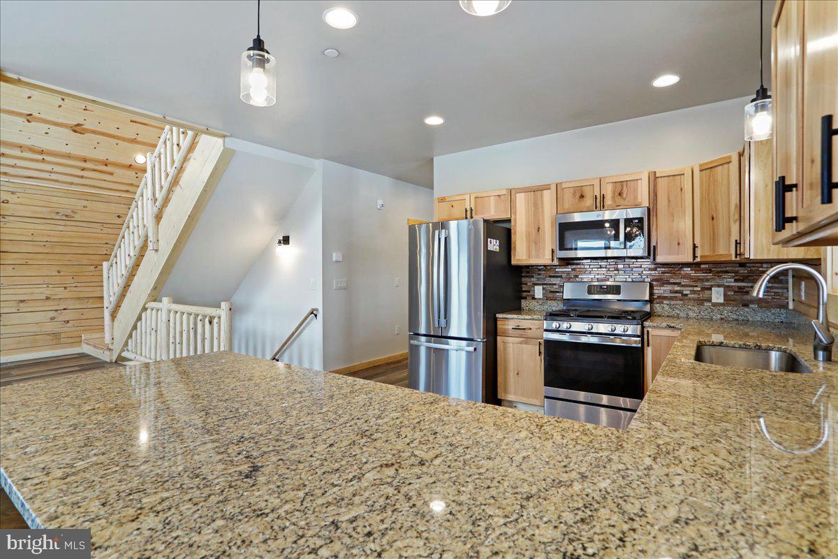 957 North Camp Road McHenry, MD 21541 - Photo 11 of 53 a kitchen with stainless steel appliances granite countertop a refrigerator a stove top oven a sink and dishwasher
