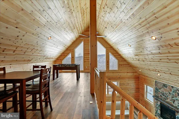 a bedroom with a bed wooden floor and window