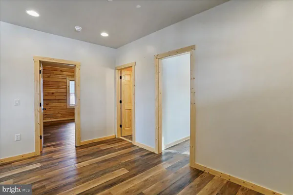 a spacious bedroom with a bed and a window