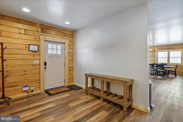 a view of a bedroom with wooden floor and a window