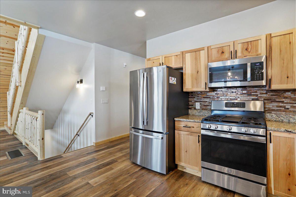 957 North Camp Road McHenry, MD 21541 - Photo 9 of 53 a kitchen with a stove a microwave and a refrigerator