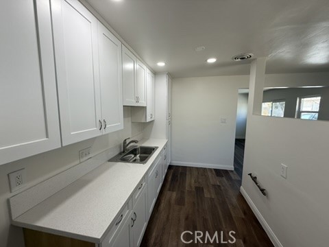 8044 Michael Drive San Bernardino, CA 92410 - Photo 11 of 22 a kitchen with a sink and wooden floor
