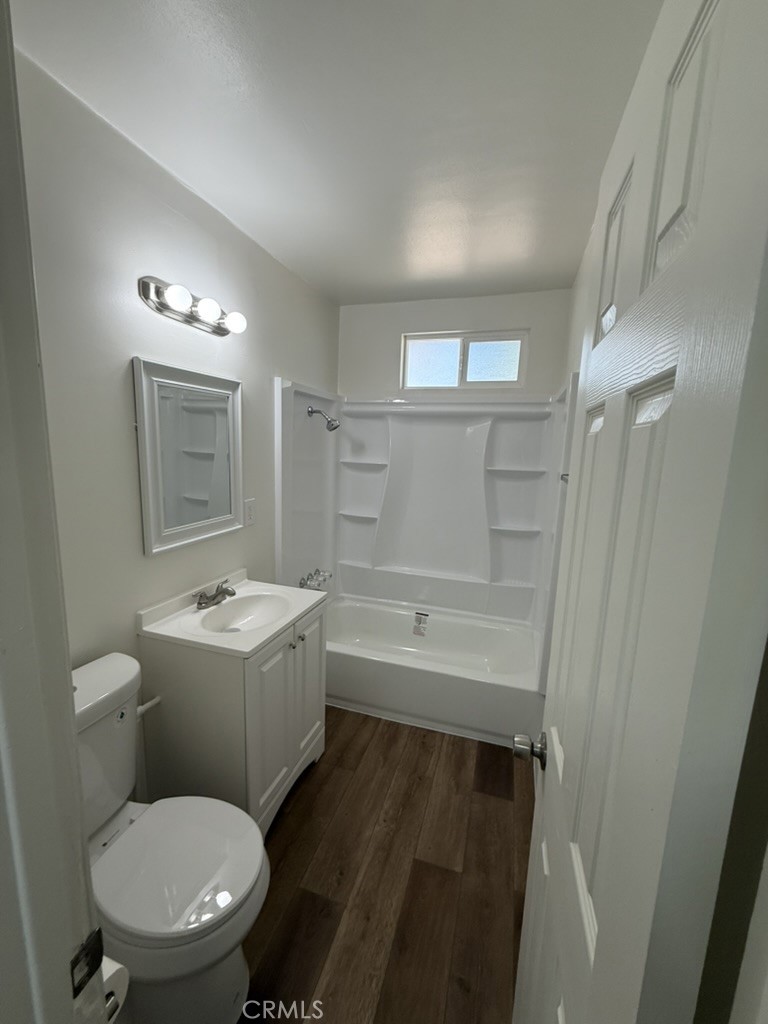 8044 Michael Drive San Bernardino, CA 92410 - Photo 17 of 22 a bathroom with a toilet a sink and bathtub