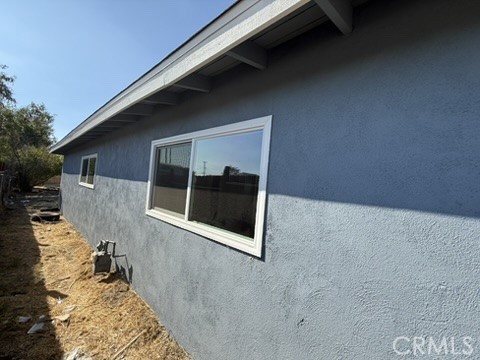 8044 Michael Drive San Bernardino, CA 92410 - Photo 5 of 22 a front view of a house with a yard