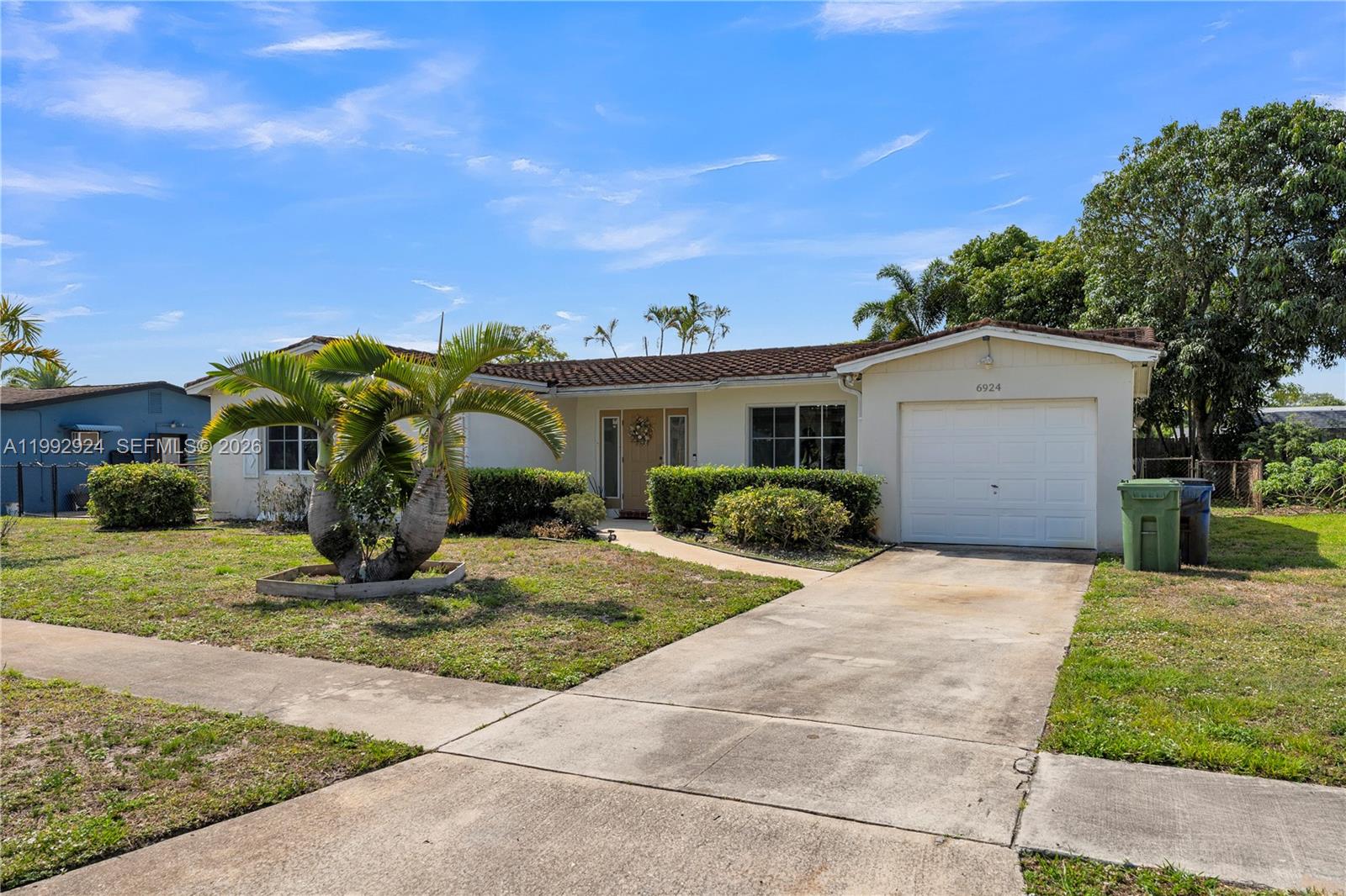 6924 Northwest 8th Court Margate, FL 33063 - Photo 1 of 38 a view of a house with backyard and trees