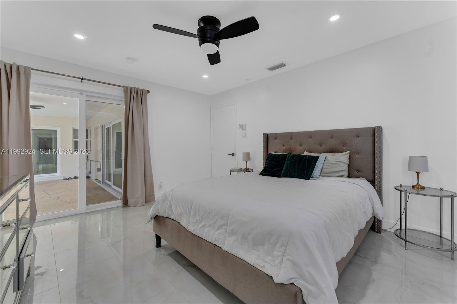 6924 Northwest 8th Court Margate, FL 33063 - Photo 21 of 38 a bedroom with a bed and a chandelier