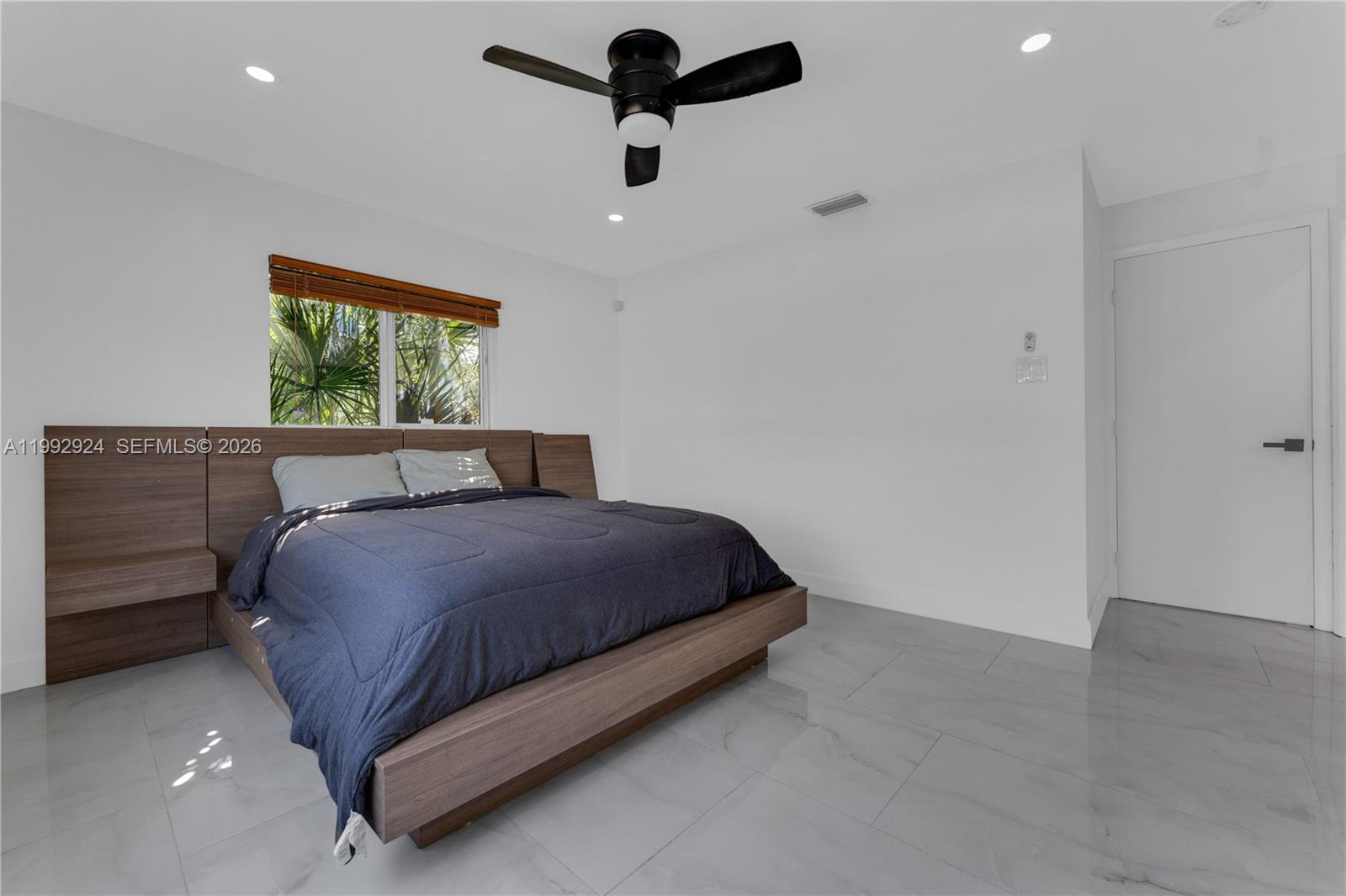 6924 Northwest 8th Court Margate, FL 33063 - Photo 25 of 38 a bedroom with a bed and a window