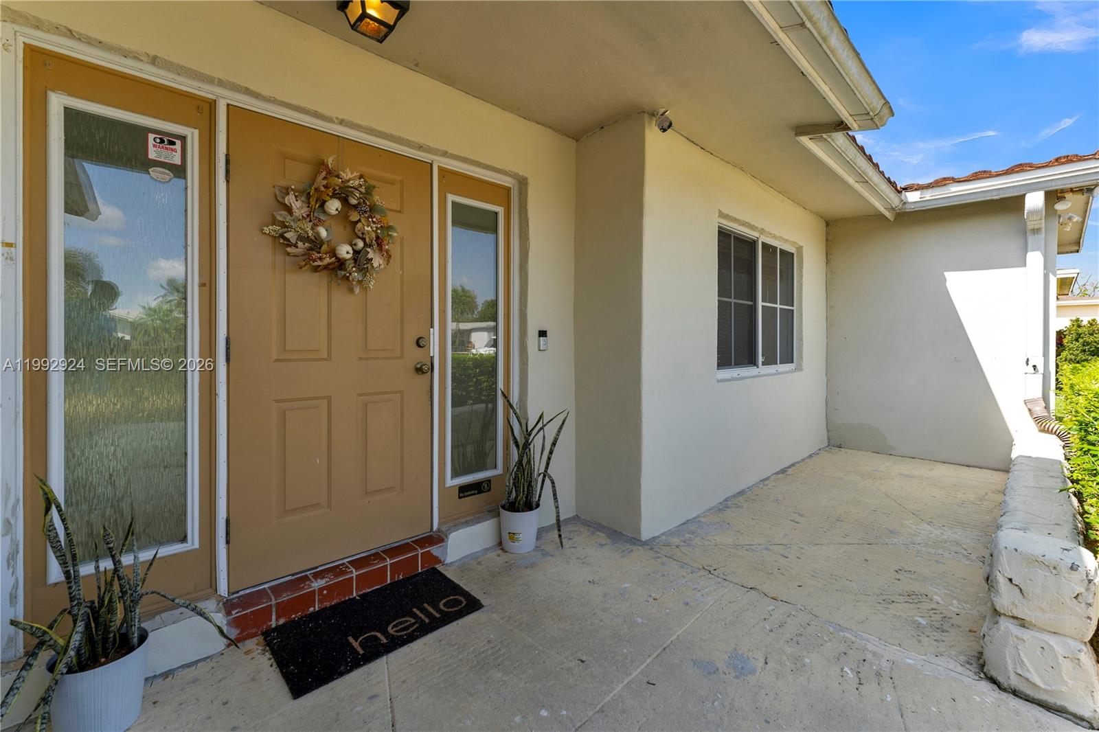 6924 Northwest 8th Court Margate, FL 33063 - Photo 5 of 38 a view of a hallway with a glass door and furniture