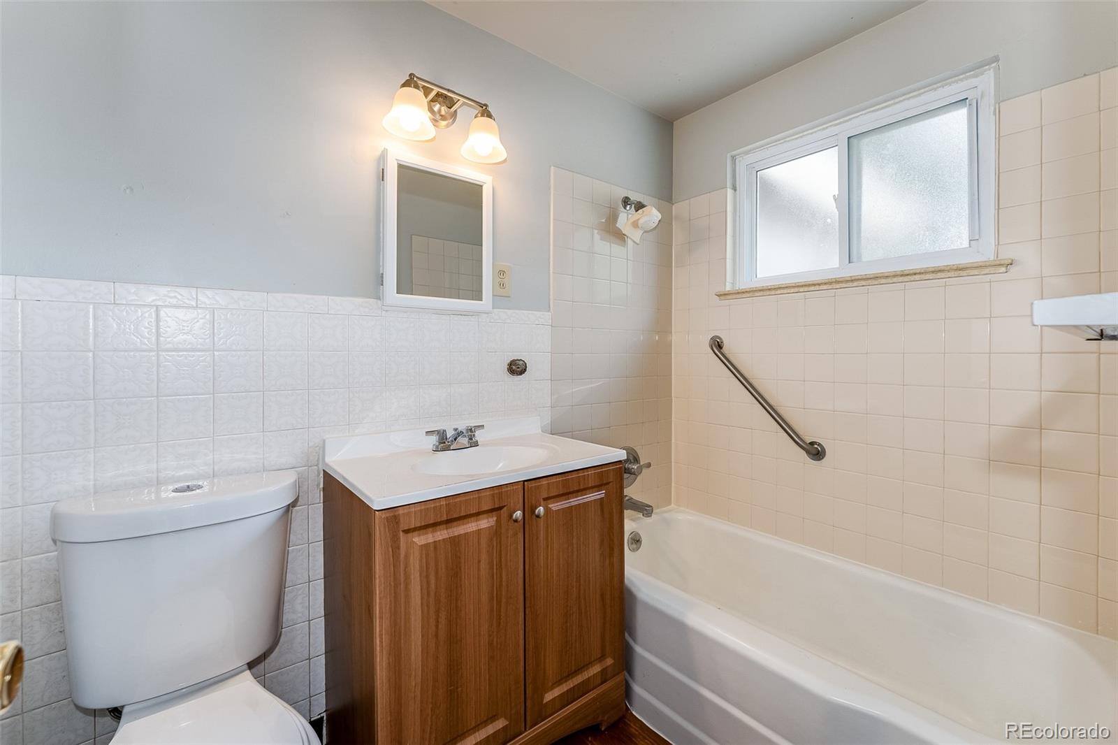 2817 Gray Street Wheat Ridge, CO 80214 - Photo 18 of 18 a bathroom with a sink toilet vanity and bathtub
