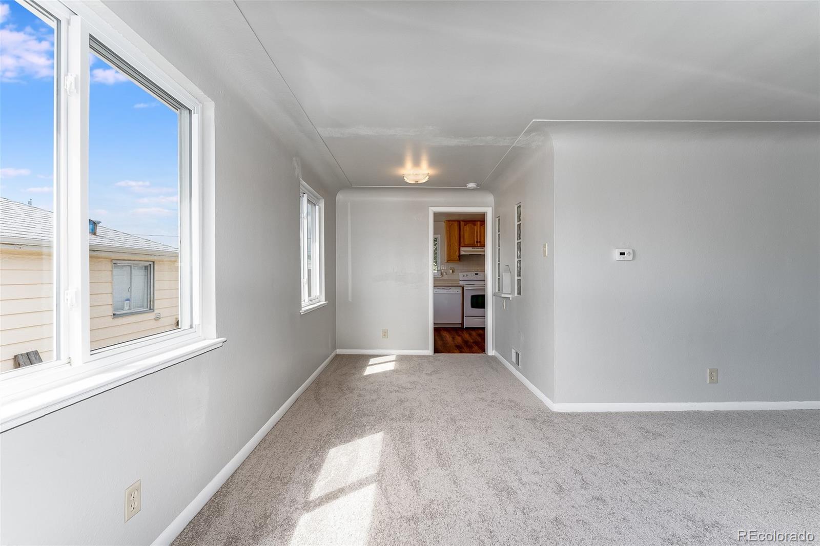 2817 Gray Street Wheat Ridge, CO 80214 - Photo 5 of 18 an empty room with windows and closet