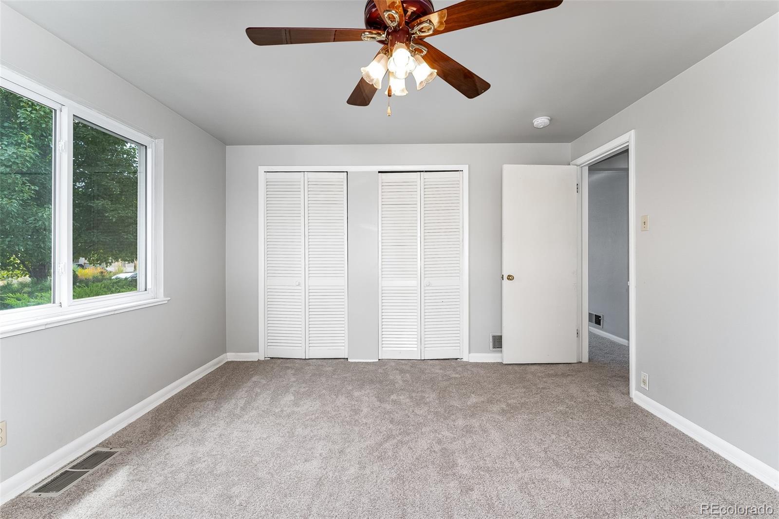2817 Gray Street Wheat Ridge, CO 80214 - Photo 6 of 18 a view of an empty room with window chandelier fan