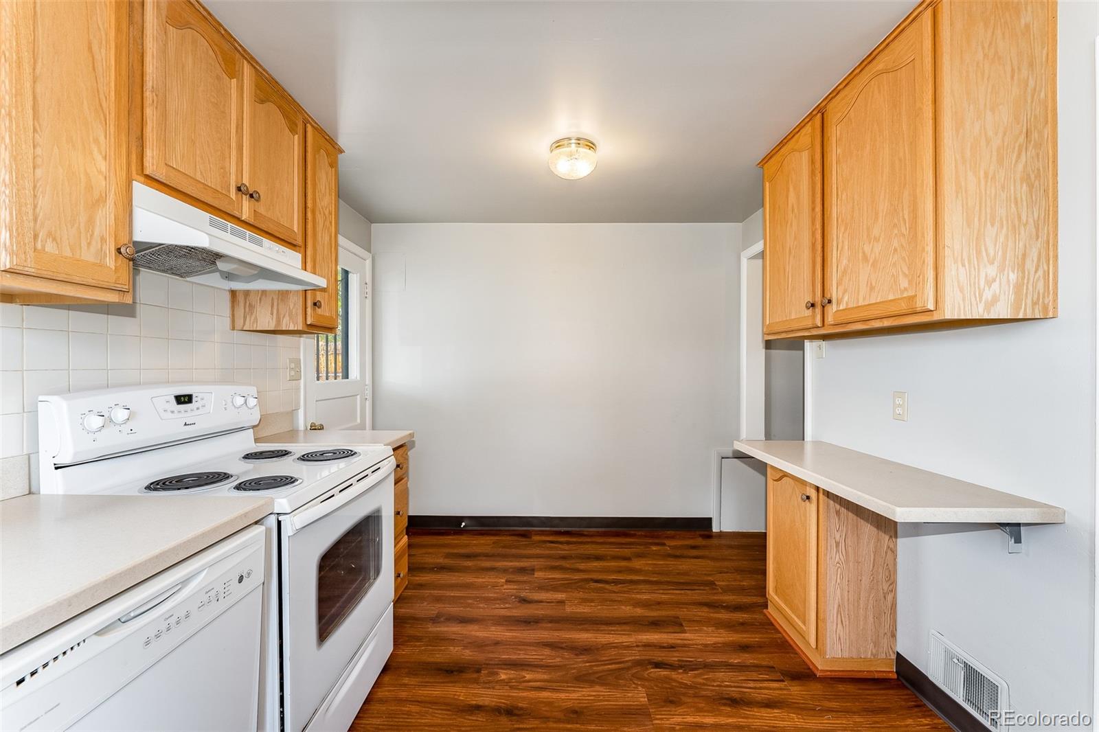 2817 Gray Street Wheat Ridge, CO 80214 - Photo 9 of 18 a view of a kitchen with stove and cabinets