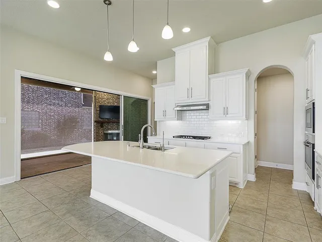 a kitchen with stainless steel appliances granite countertop a stove and a refrigerator