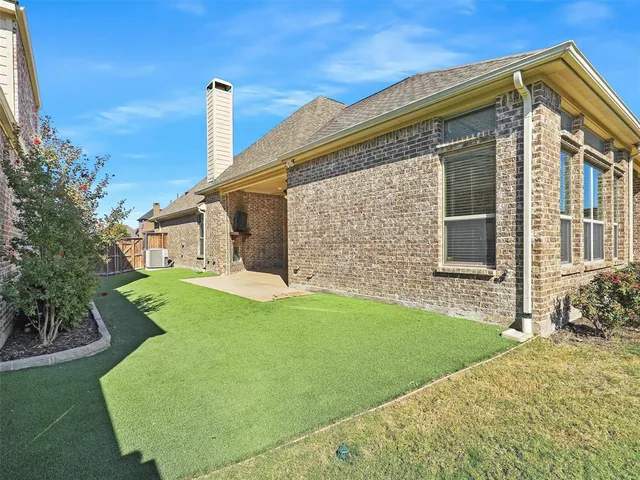 a view of a house with a yard and stairs