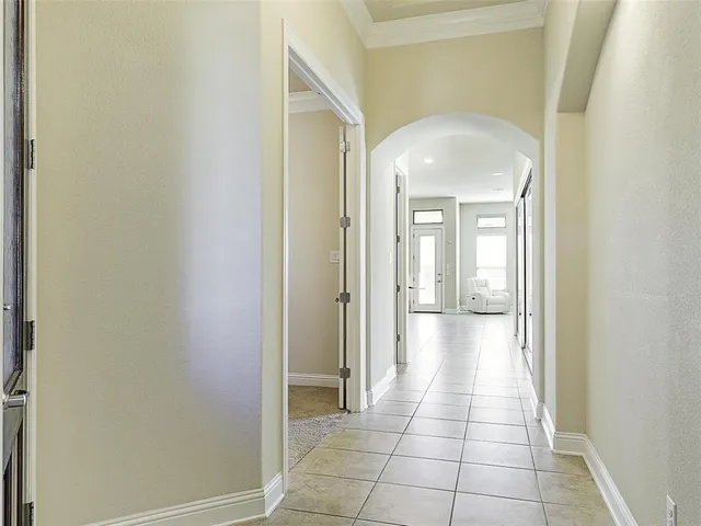 a view of a hallway with a glass door and a window