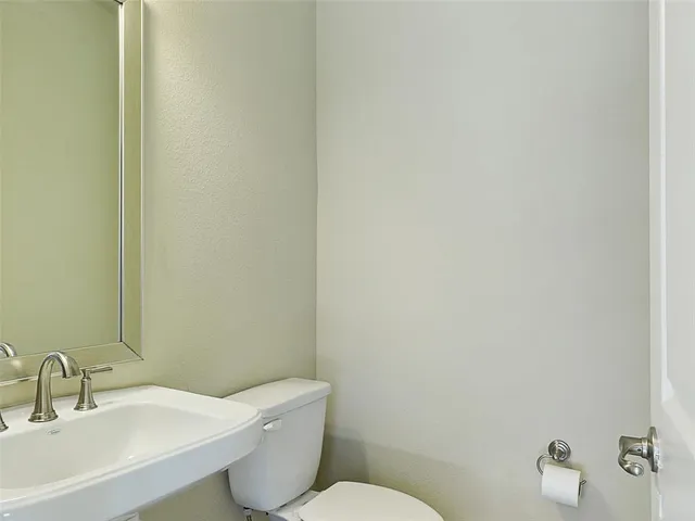 a white toilet sitting next to a bathroom sink