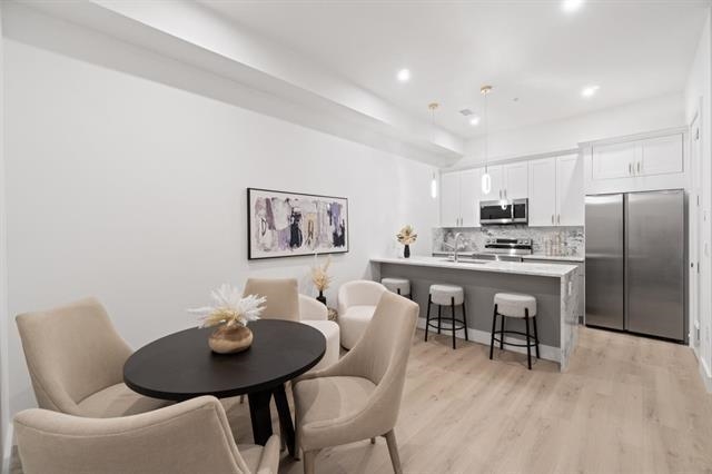 491 Broadway, Unit 402 Bayonne, NJ 07002 - Photo 5 of 20 a view of a dining room with furniture and wooden floor