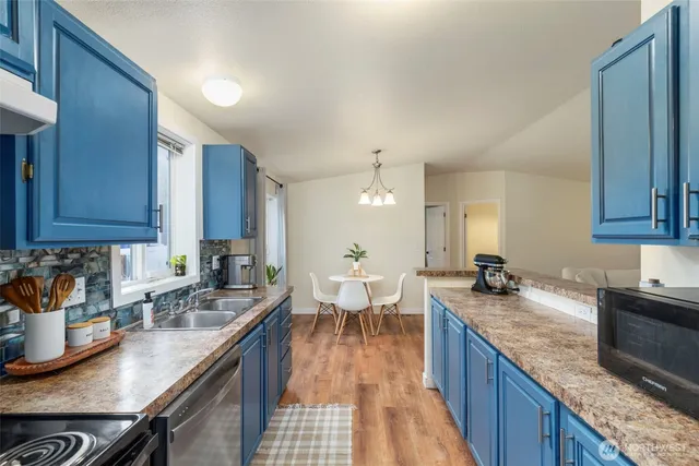 a kitchen with granite countertop lots of counter top space and dining table