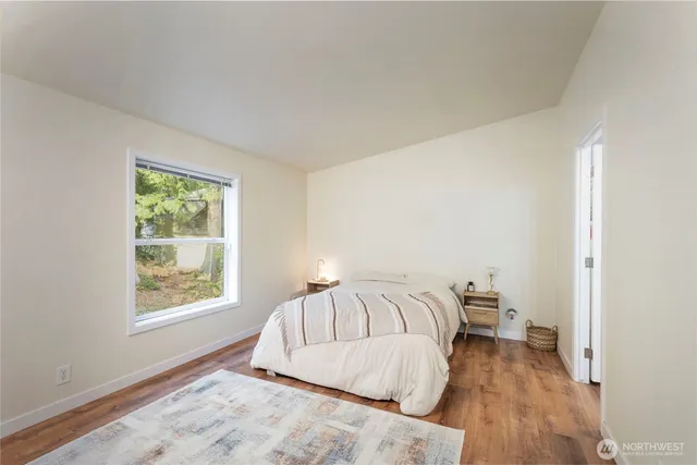 a view of a bedroom with wooden floor and bedroom