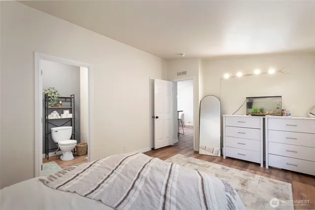 a bedroom with a bed and dresser