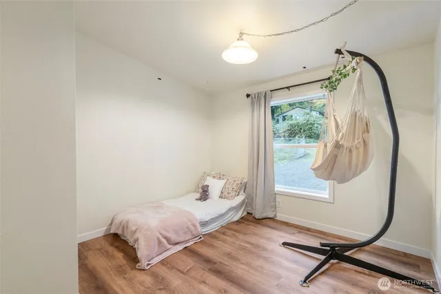 a bedroom with a bed and a mirror