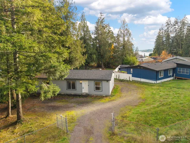 a aerial view of a house with swimming pool next to a yard