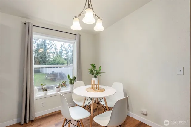 a view of a dining room with furniture window and wooden floor