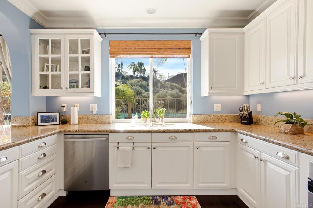 4183 Twilight Ridge San Diego, CA 92130 - Photo 11 of 46 a kitchen with granite countertop white cabinets and white appliances