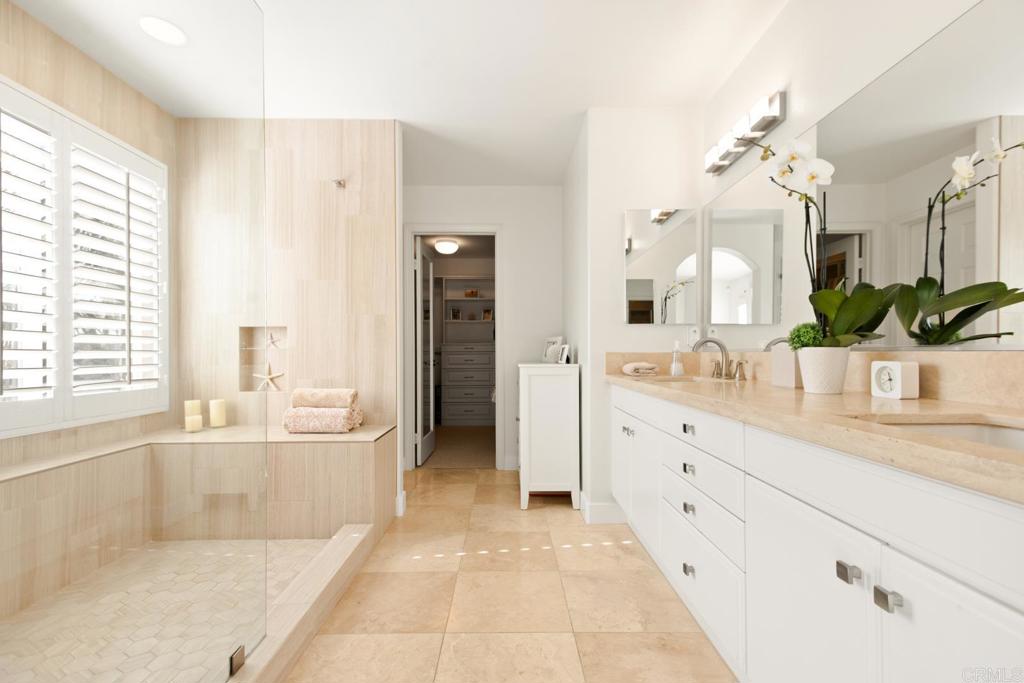 4183 Twilight Ridge San Diego, CA 92130 - Photo 16 of 46 a spacious bathroom with a granite countertop sink a mirror a bathtub and next to a window