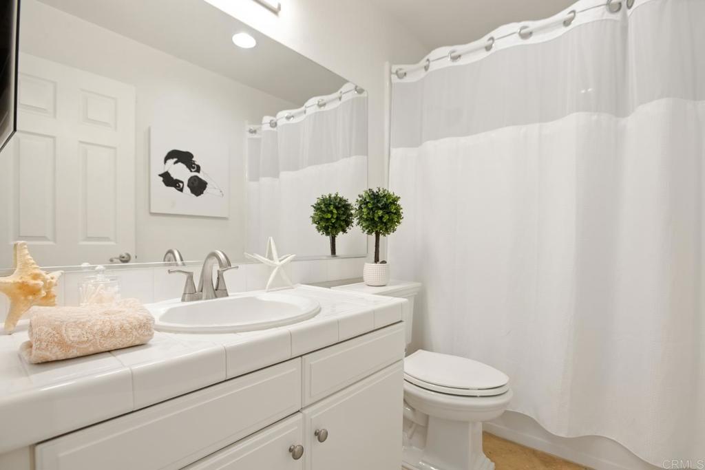 4183 Twilight Ridge San Diego, CA 92130 - Photo 23 of 46 a bathroom with a sink a toilet and mirror