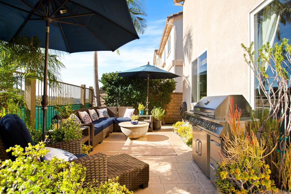 4183 Twilight Ridge San Diego, CA 92130 - Photo 29 of 46 a view of a patio with table and chairs under an umbrella