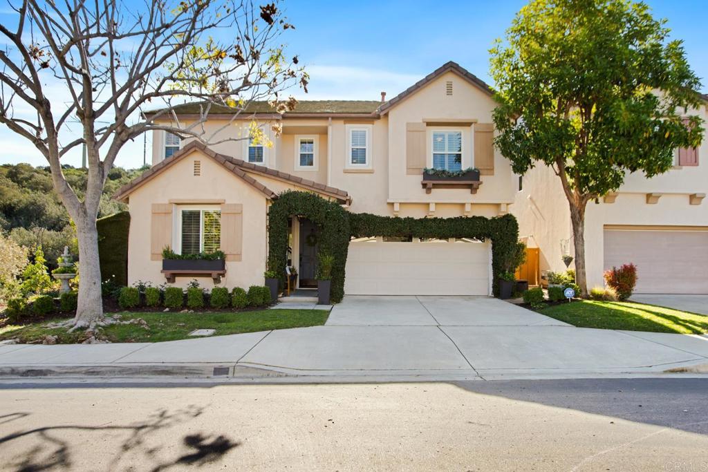 4183 Twilight Ridge San Diego, CA 92130 - Photo 3 of 46 a front view of a house with a yard and garage