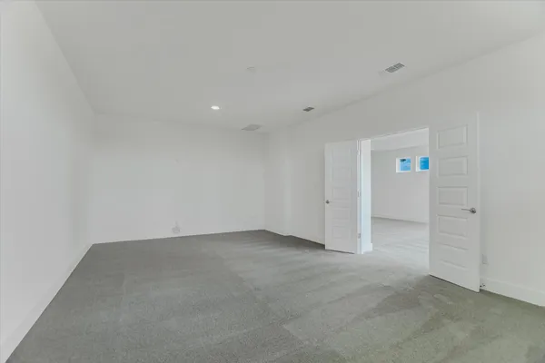 an empty room with entrance to other room