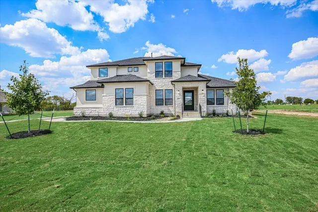 a front view of a house with a yard