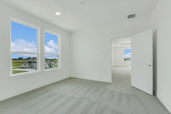 an empty room with windows and closet
